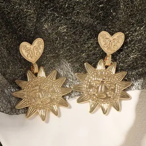 Vintage golden sun and heart drop earrings with embossed faces and polished finish