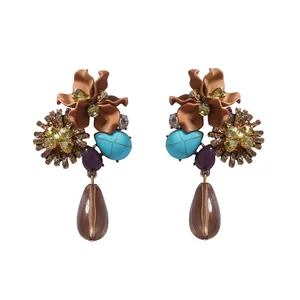 Detail of vintage resin flower earrings with turquoise beads and water drop pendants