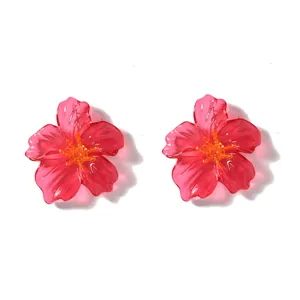 Modieuze grote transparante magenta acryl bloem oorknopjes met oranje accenten