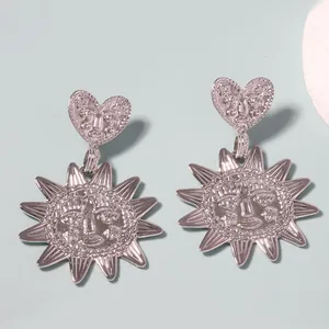 Silver alloy sunflower and heart drop earrings with vintage facial relief design
