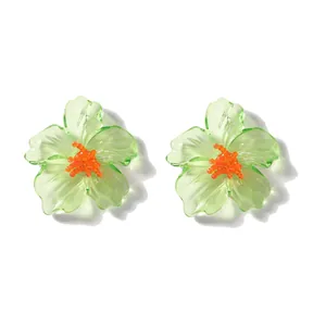 Macro-opname van doorschijnende groene acryl bloemoorbellen met een oranje hartje