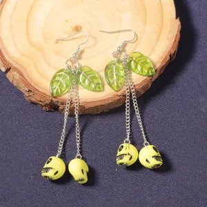 Creative cherry skull long pendant earrings with green leaves and yellow skull charms