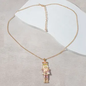 Golden nutcracker soldier pendant necklace with pink enamel and sparkling crystals
