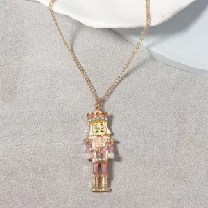 Detail view of nutcracker pendant with pink enamel, faux pearls and crystals on gold chain