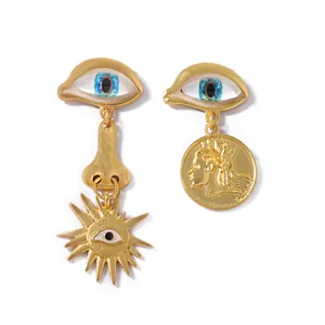 Macro detail of vintage asymmetrical Evil Eye earrings with gold coin and nose pendants