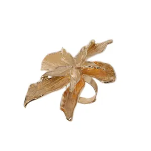 Exaggerated gold orchid flower statement ring with detailed brushed metal texture for women