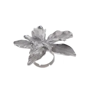 Macro detail of silver flower ring showing textured petals and adjustable open band