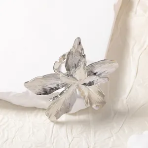 Elegant silver flower open ring with brushed metal texture and artistic lily design
