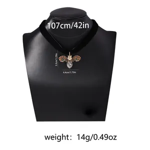 Detail view of crystal bee pendant necklace with size labels and velvet strap length