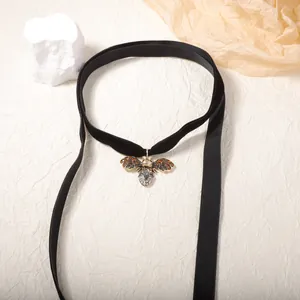 Vintage style bee pendant necklace with rhinestones on a black velvet ribbon choker