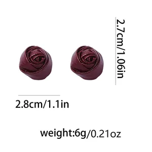 Detailed view of burgundy faux leather rose earrings with 2.7cm size specifications