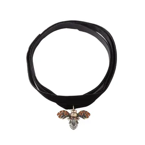 Vintage velvet choker necklace featuring a delicate gold bee pendant with rhinestones