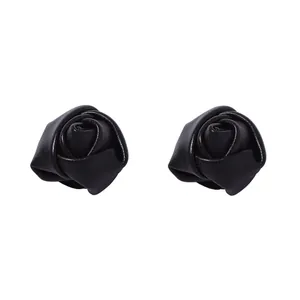 Detailed close-up of handmade black leather rose earrings with realistic petal textures