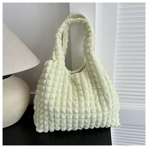 Close-up of light yellow tote bag featuring unique popcorn textured fabric in a modern setting