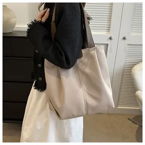 Bolso tote minimalista de gran capacidad color blanco roto usado por una modelo de lado