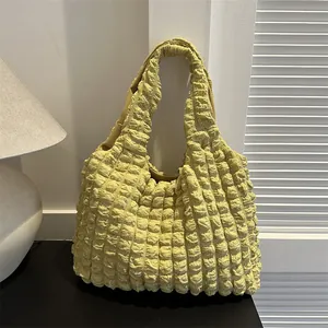 Pale green popcorn bubble tote bag with pleated texture and wide shoulder strap
