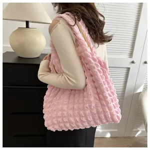 Detail of light pink popcorn texture fabric on a large capacity shoulder tote bag