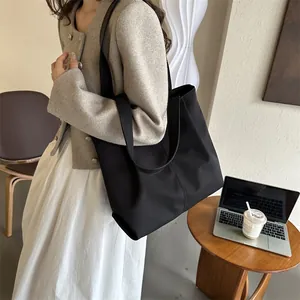 Bolso tote de lona negra para mujer con gran capacidad y correa de hombro minimalista