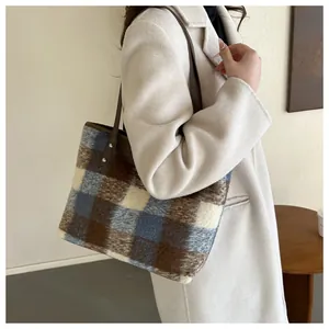 Detail of plush checkered tote bag featuring soft brown faux fur and leather shoulder strap
