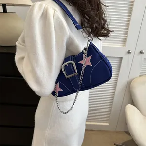 Y2K style blue canvas shoulder bag with pink star patch and silver chain detail