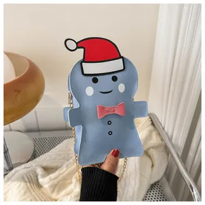 Detail of light blue gingerbread man bag with red Christmas hat and gold chain strap