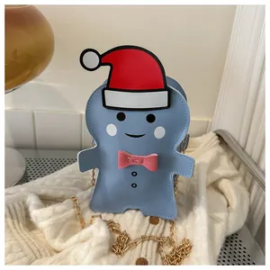Blue gingerbread man crossbody bag with red Santa hat and gold chain strap detail