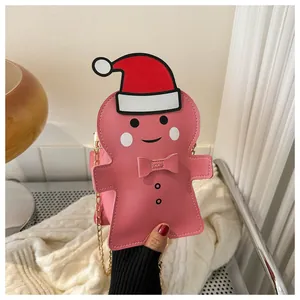 Pink gingerbread man crossbody bag with a Santa hat and golden metal chain strap