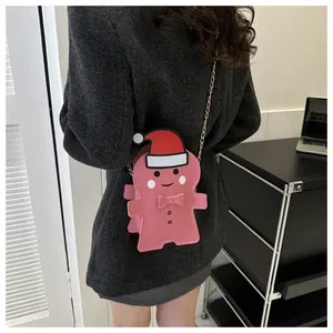Gingerbread man crossbody bag with pink leather finish and metal chain shown on model