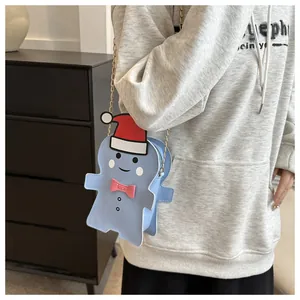Detail of cute light blue Christmas character crossbody bag with gold chain strap