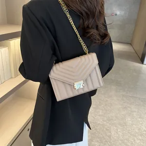 Beige quilted chain flap shoulder bag styled with a classic black blazer for city commute