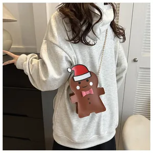 Gingerbread man crossbody bag with gold chain worn by model for Christmas gifts