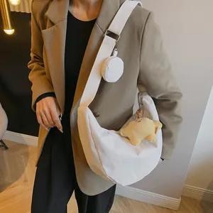 White corduroy crescent crossbody bag with mini pouch and yellow star plush charm