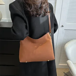 Caramel brown vintage suede tote bag with slim shoulder strap and golden metal buckle