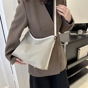 Chic beige canvas hobo shoulder bag with white leather trim and gold hardware for women