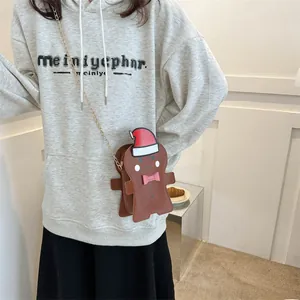 Gingerbread man crossbody bag with Christmas hat and gold chain for festive gift wrapping