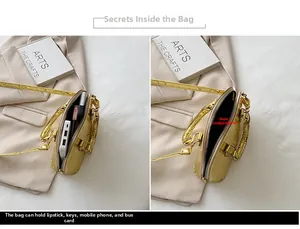 Detail view of gold shell bag interior storage and glossy quilted leather texture