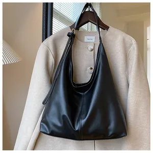 Large black matte faux leather tote bag with vertical stitching for daily commute