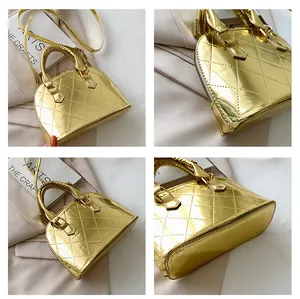 Detailed close-up of glossy gold quilted shell bag with metallic finish and texture