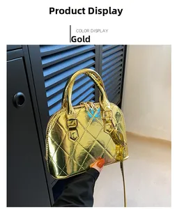 Detail of gold shell bag featuring quilted diamond pattern and glossy patent finish