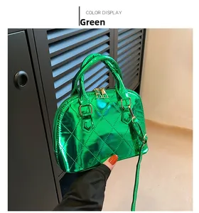 Detail of green patent leather shell bag featuring quilted stitching and gold hardware