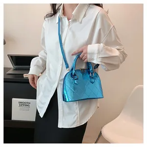 Detail of glossy blue shell bag with diamond quilted pattern and silver metallic finish