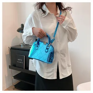 Detail of blue glossy shell bag with quilted stitching pattern and shiny finish
