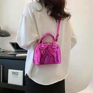 Metallic rose pink shell bag with quilted rhombic pattern and glossy finish