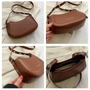 Vue détaillée du sac demi-lune marron avec fermeture éclair et bandoulière réglable