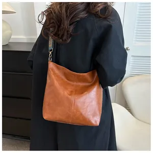 Brown soft leather hobo bag featuring a vintage embroidered wide shoulder strap detail