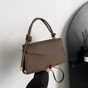 Brown gradient leather shoulder bag with knotted handle and envelope flap closure
