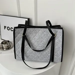 Chic grey felt tote bag with diamond quilted stitching and black trim details
