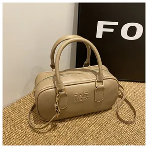 Detail view of khaki Boston handbag showing FAS HON texture and adjustable strap