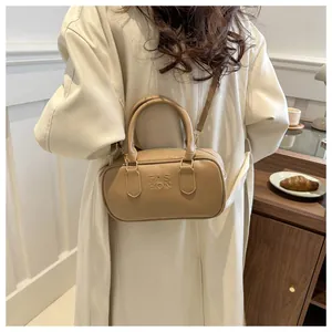 Close-up of khaki leather Boston bag with FAS HON embossed design and top handles
