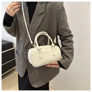 Detail of white leather shoulder bag with Fashion embossed logo and gold hardware